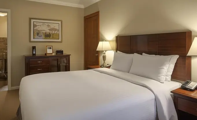 Comfortable hotel room in Reggio Calabria with double bed, bedside tables, and warm lighting